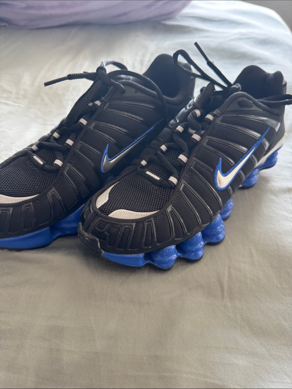 Nike Black Sneakers with Blue Accents and Cushioning Pods